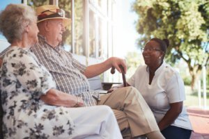 caregiver talking to older couple