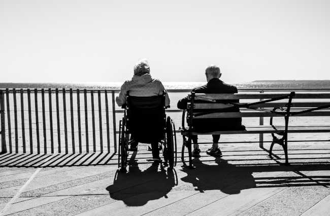 Elderly couple sitting by the beach