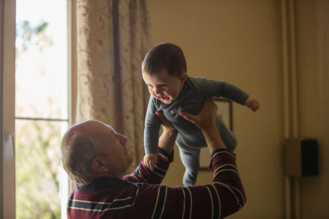elderly man at home with his grandson