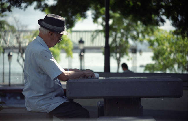 elderly man sitting on a bench in the park