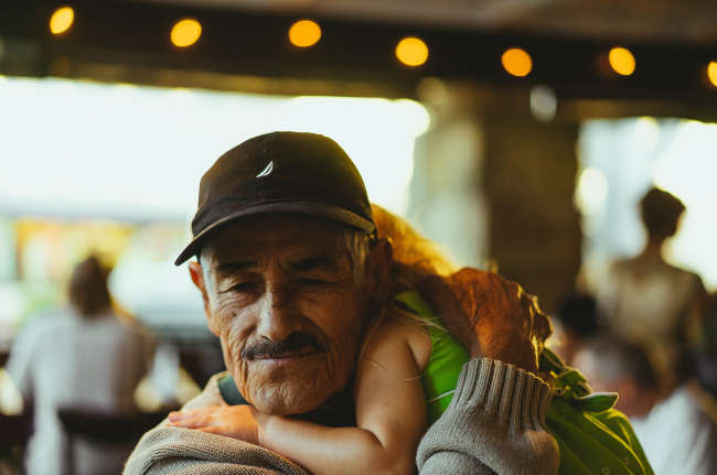 elderly man holding his grandchild