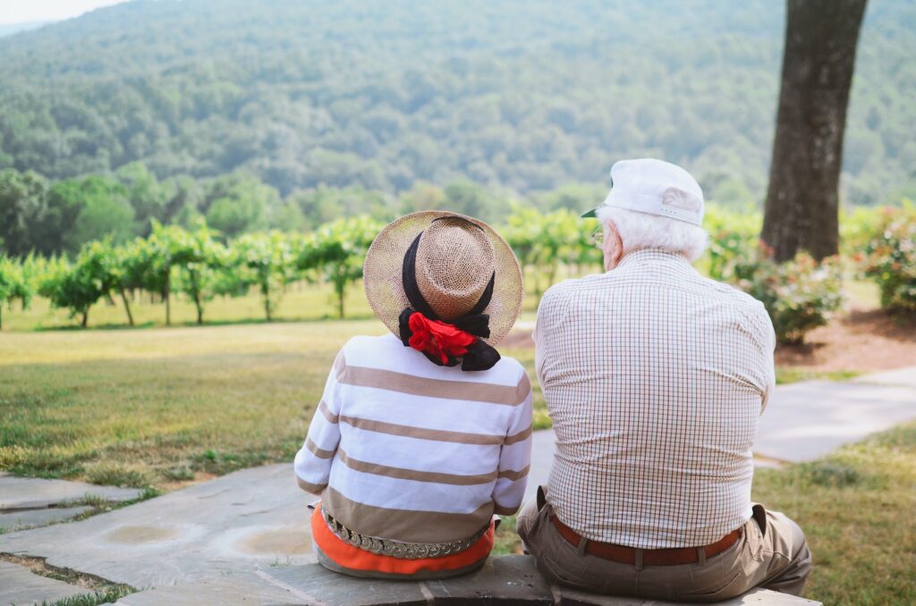 elderly-couple-sitting-at-vineyard